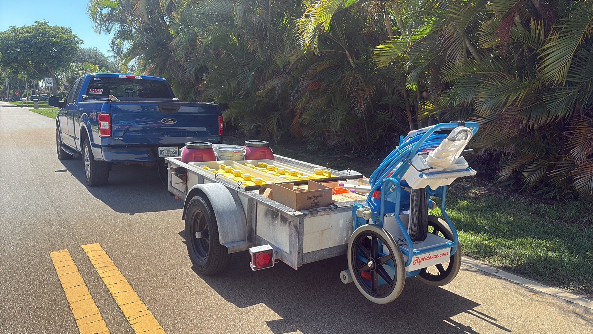 Our truck on route Collegiate Pools service truck and trailer loaded with chemicals on a Palm Beach County route